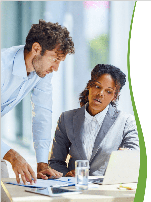 Two colleagues in front of a laptop and reviewing paperwork 7 Steps to Success: Proactive Denials Management and Prevention | Savista Syndicated Content