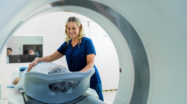 Woman nurse or technician helping a patient about to go into an MRI Healthcare Finance Trends for 2026 | CommerceHealthcare®